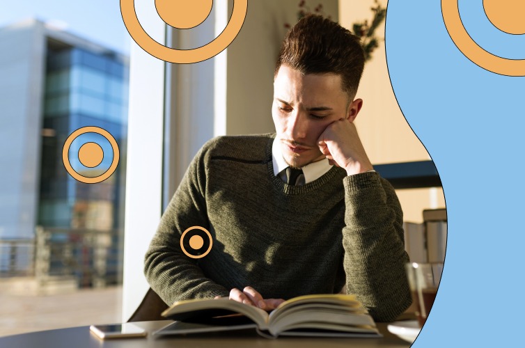 Man contemplatively reading a textbook in his office