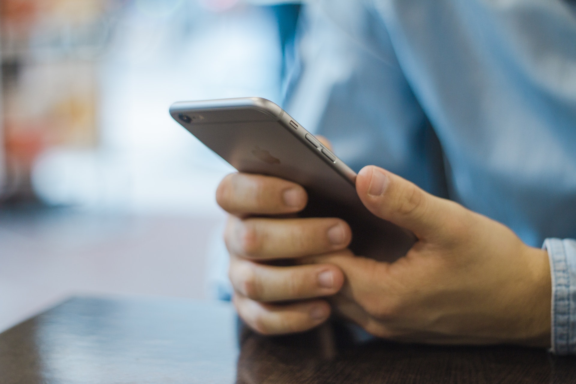 Set of hands holding an iPhone