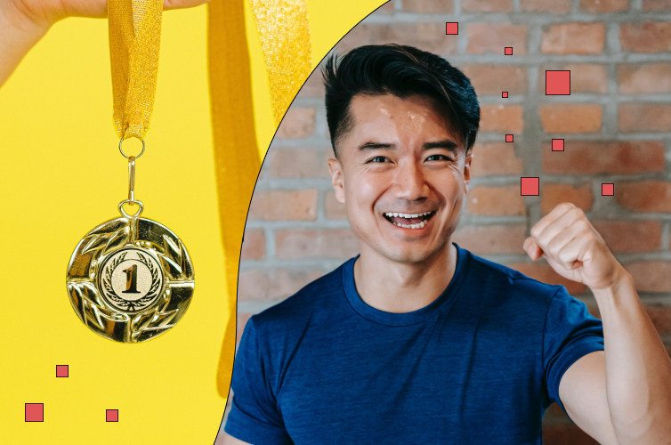 Man smiling with his fist in the air next to a gold medal