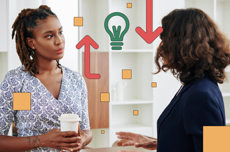 Two women talking to each other in the office