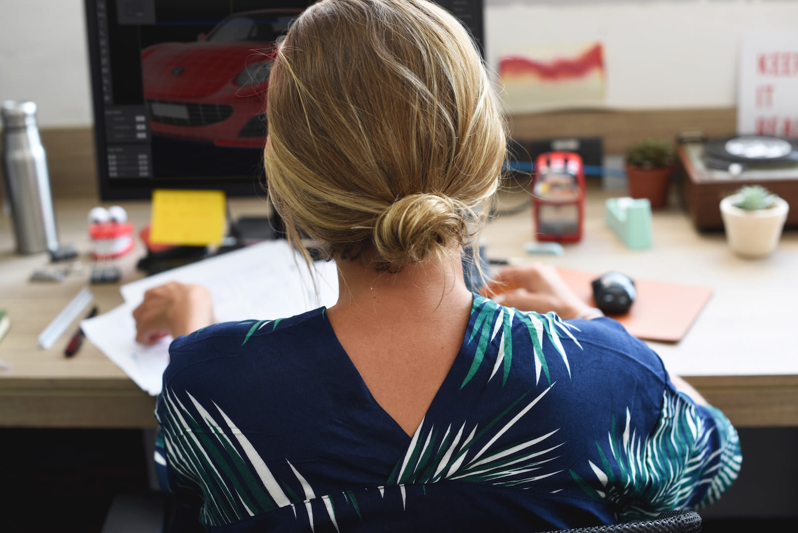 Woman sitting at a desk with her back to the camera