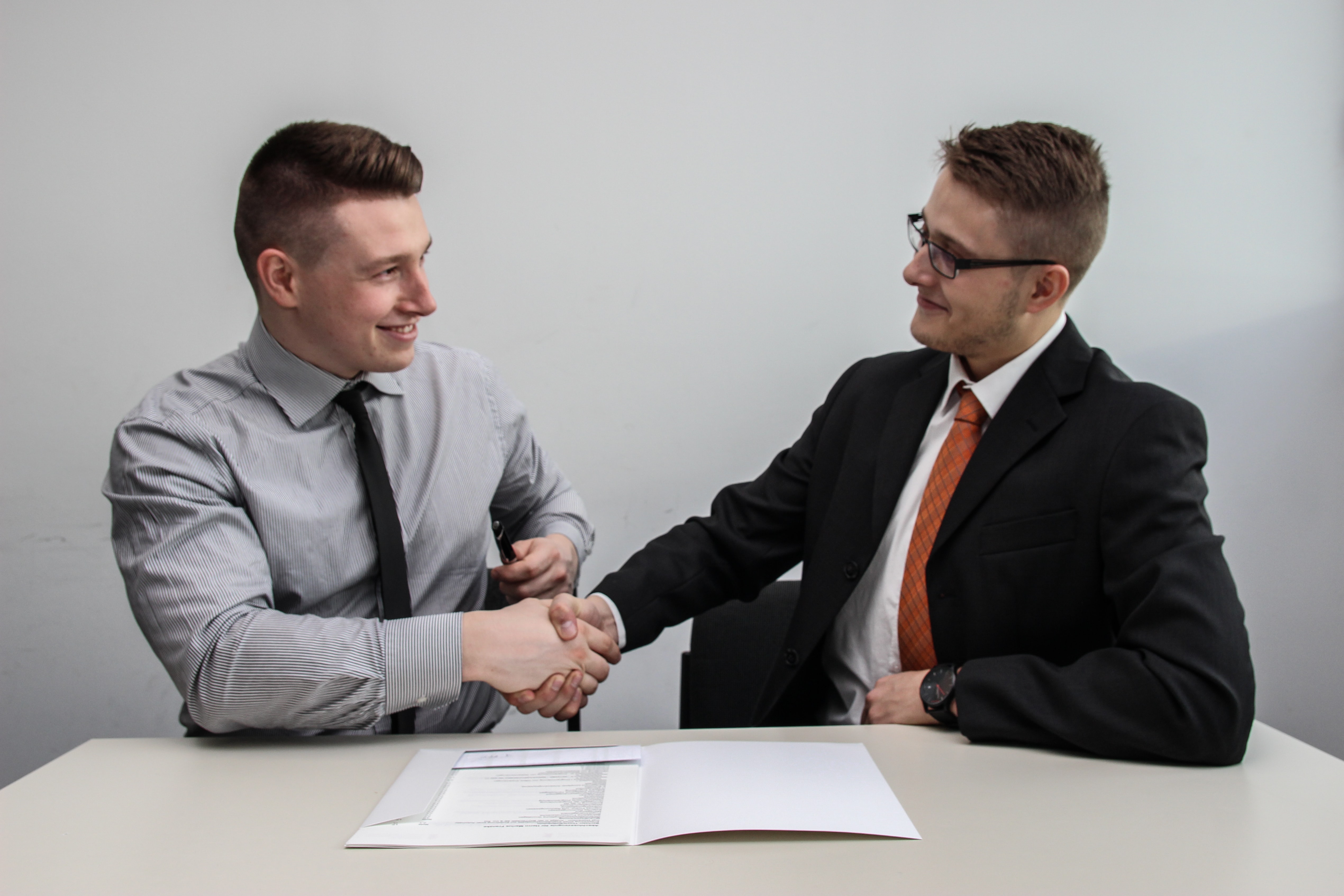 Two businessmen shaking hands after a job interview. 