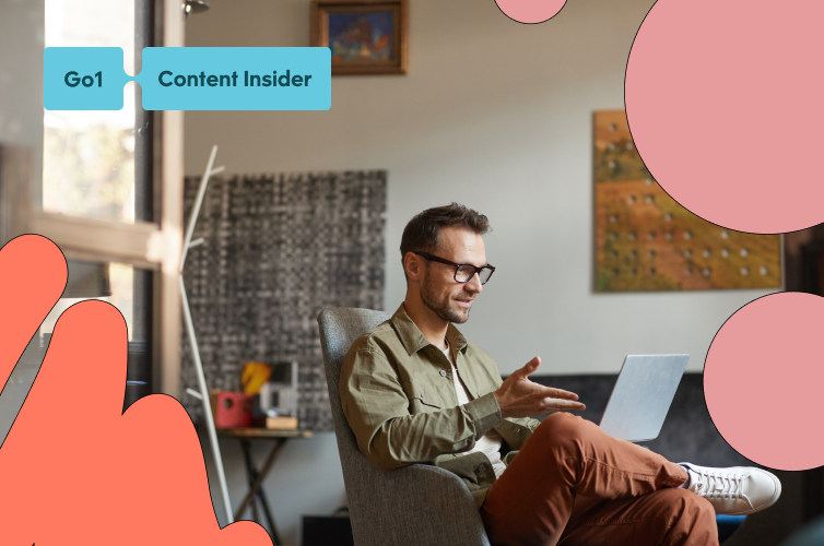 Man sitting casually gesturing hand at laptop