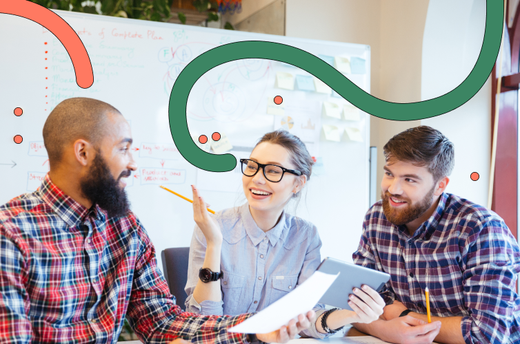 Three people at a desk chatting