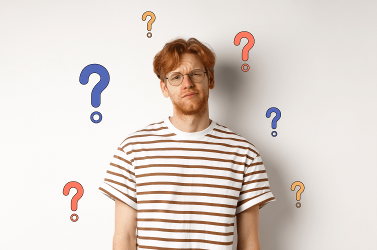 Man standing with his back against a wall looking puzzled