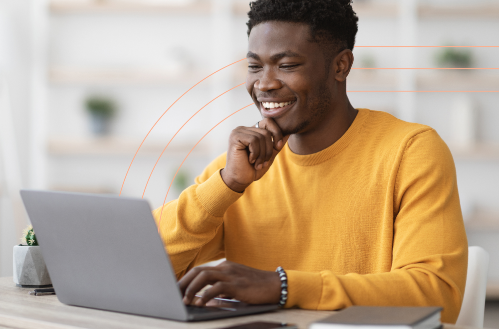 Man working on his laptop and smiling