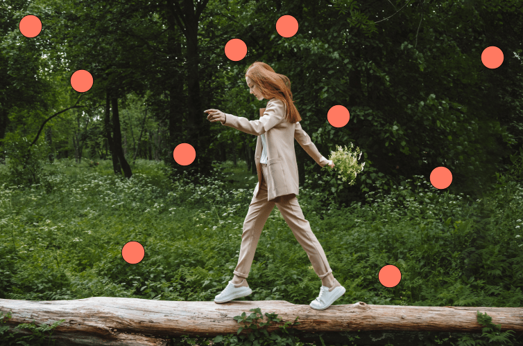 Image of adult balancing on log in forest