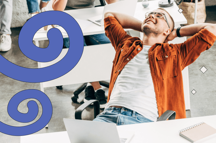 Worker leans back happily at his desk