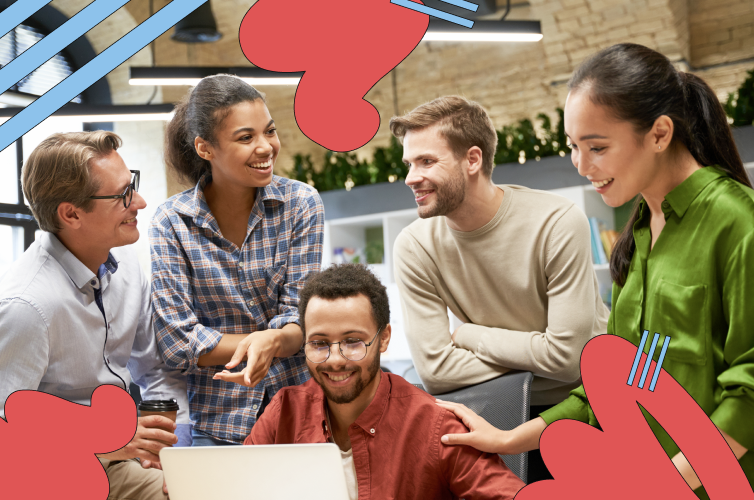 A group of co-workers gathered around a laptop smiling and talking, representing an authentic and transparent conversation